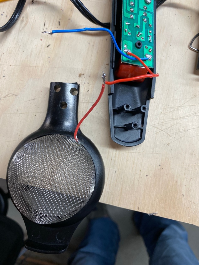 Hand strainer with handle cut off, holes drilled to match screw posts. Red wire soldered to screen.