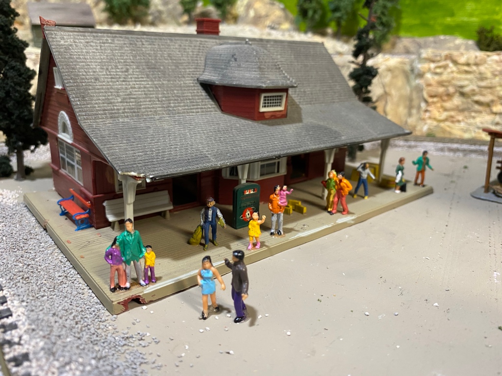 HO scale train station with many passengers.