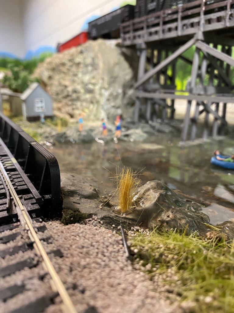 Railroad trestle in HO scale, river, weeds, ground cover, people